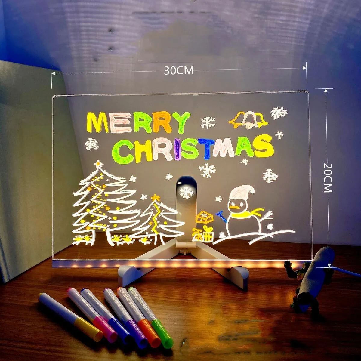 Acrylic DIY LED message board night light on a desk with handwritten drawing glowing softly.