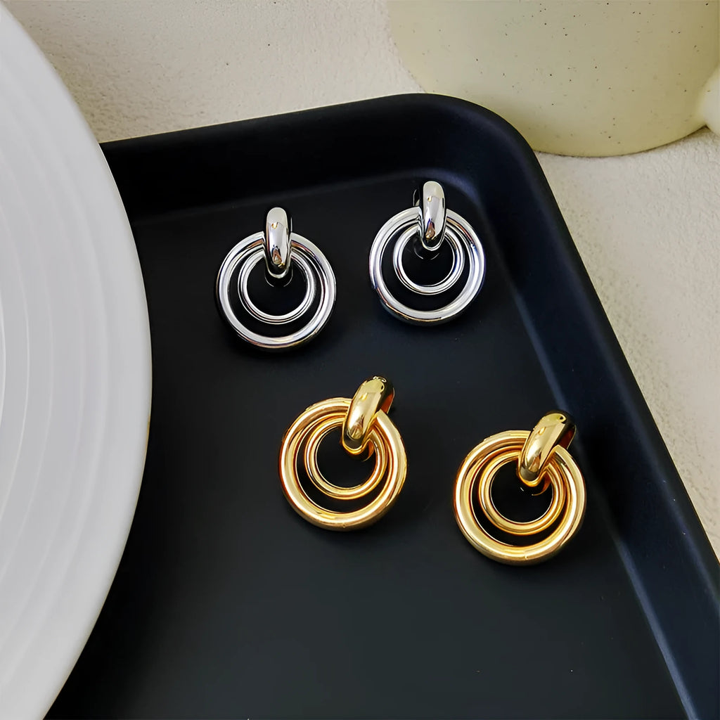 Geometric round ring earrings in gold or silver colour with irregular exotic styling