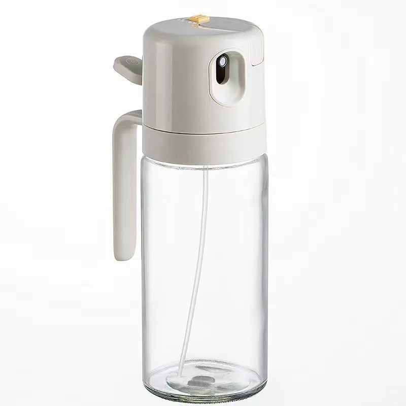 Warm grey glass 2-in-1 oil sprayer and pourer bottle with switchable cap on kitchen counter