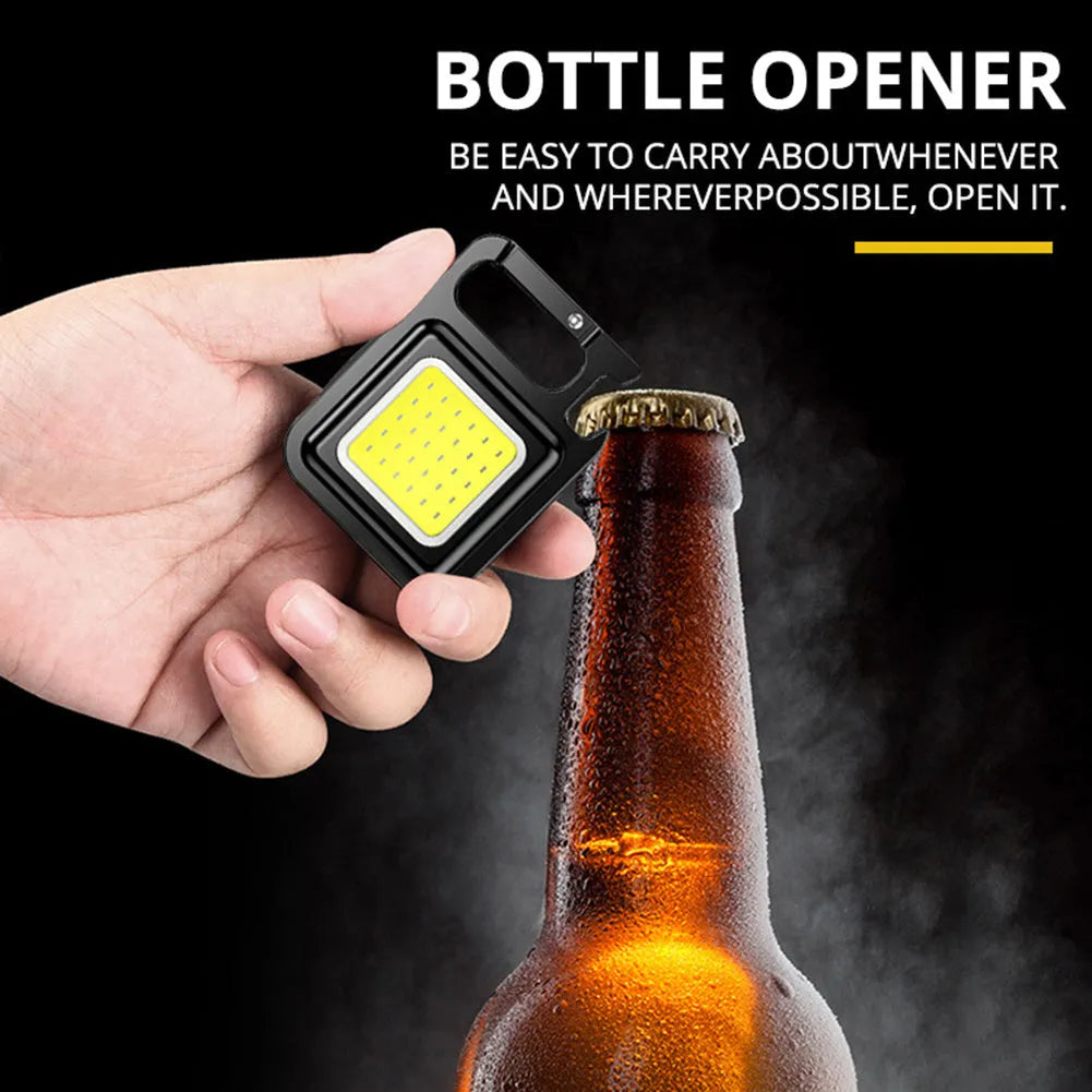 Mini keychain flashlight with COB LED, 400 lumens, USB rechargeable, three modes, hook and bottle opener.