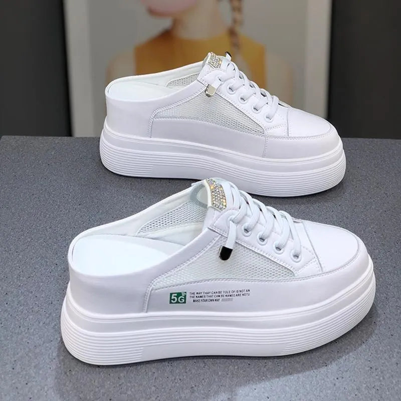 White women's platform shoes with mesh detail and a round toe on a rubber sole.