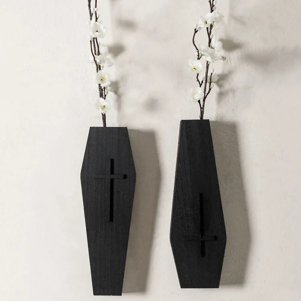Black cross-shaped wooden wall shelf measuring 27 by 9 centimetres
