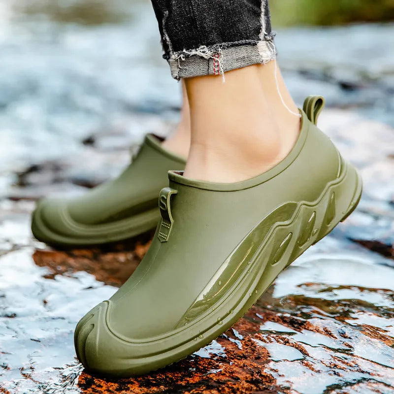 Men's short ankle-height plastic rain boot in a solid colour on a plain background.