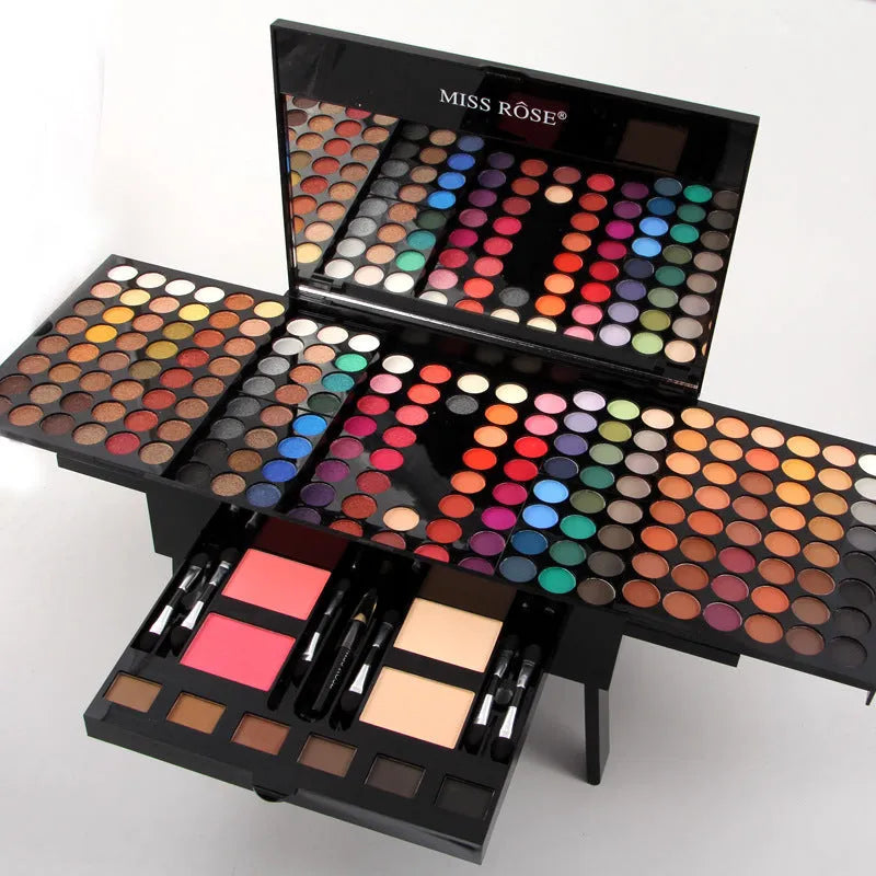Piano-shaped makeup palette open to show 180 eyeshadow colours, blushes, powders and contour shades