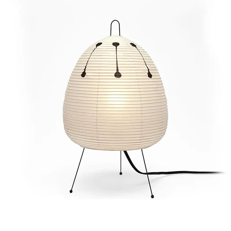 Japanese style rice paper table lamp with aluminium base on a wooden surface.