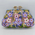 Gold oval metal evening clutch with enamel flower, hollow, diamond and dripping oil detail, 22cm long
