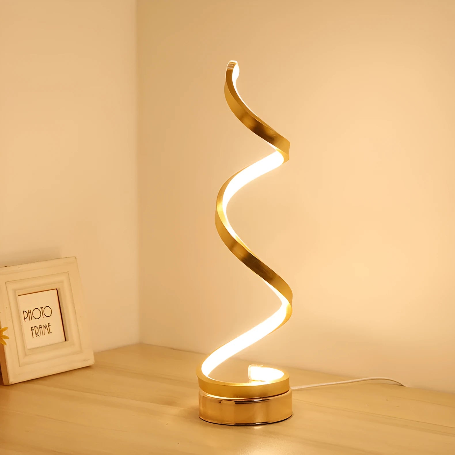Minimalist black and white LED bedside lamp with aluminium shade and tri-colour dimming on a wooden table.