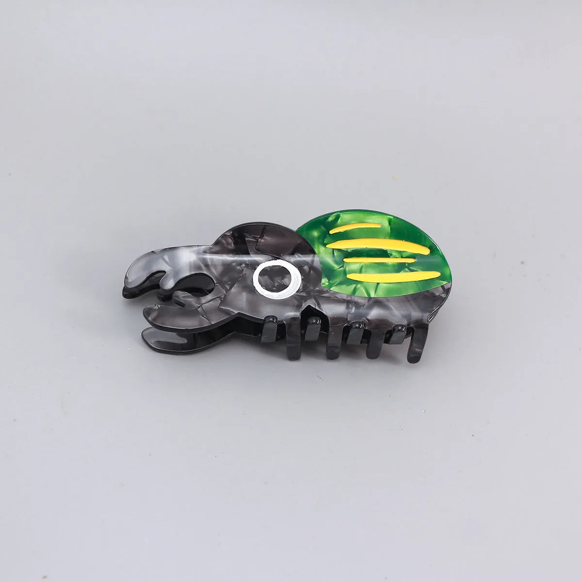 Handmade cartoon insect design hair grip in green beetle, orange beetle, or white caterpillar colour on cellulose acetate.