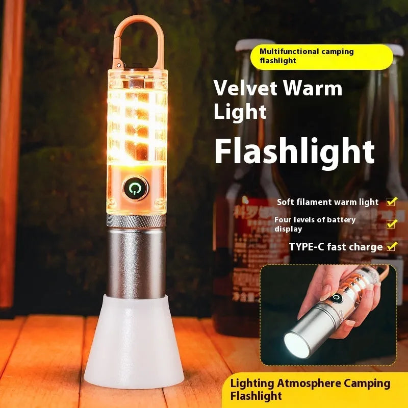 Orange or beige flashlight with dual light source, hook, and keychain, measuring 15cm in length