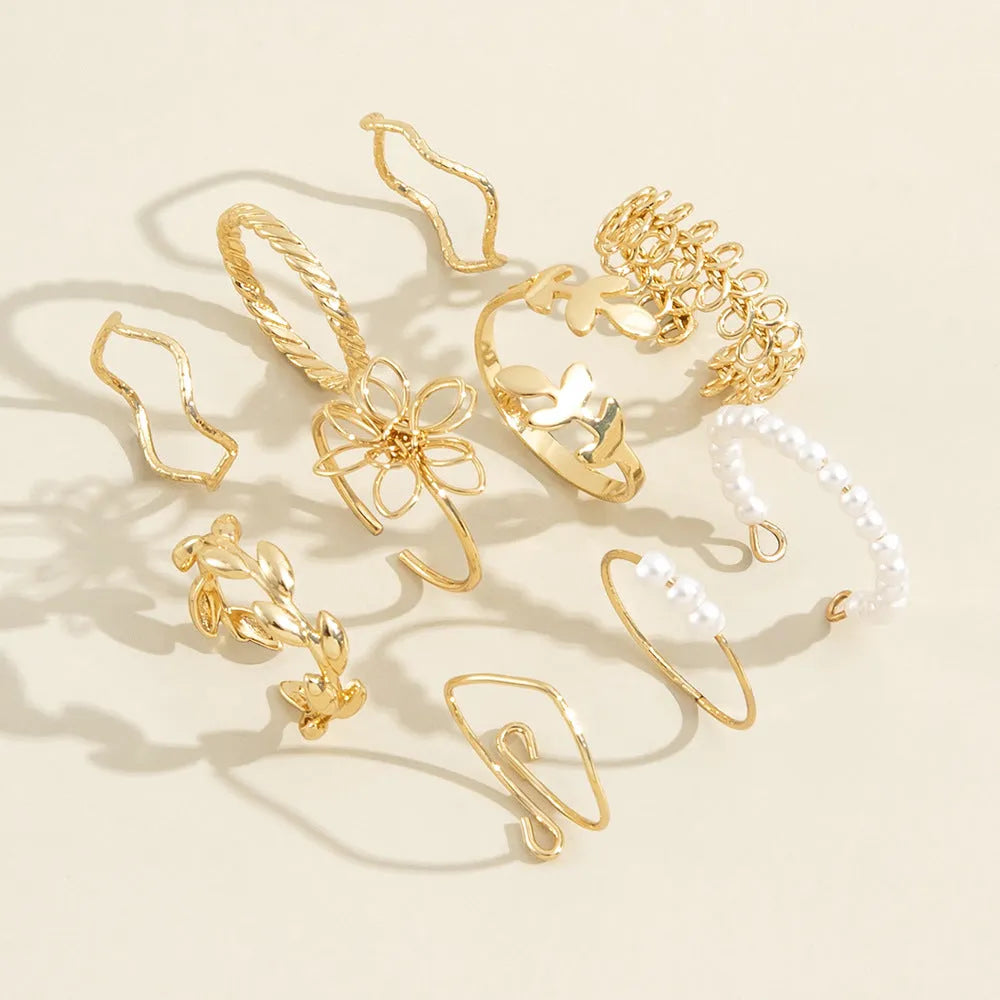Gold openwork flower ring with delicate floral design and glossy electroplated finish