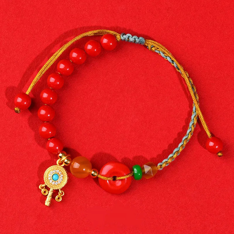 Hand-woven cinnabar bracelet with geometric peace blessing buckle in emperor red sand colour