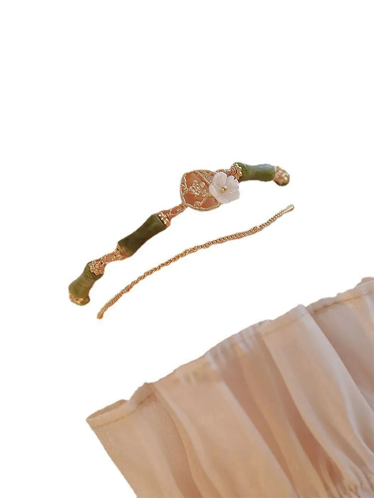 Natural olivine bracelet with double layer design featuring twin bells and olive branch motif