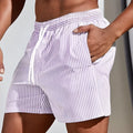 Men's loose grey mesh beach shorts on a white background, showing sporty loose fit.