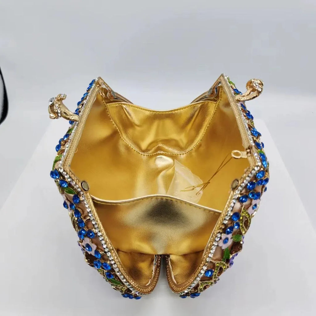 Gold oval metal evening clutch with enamel flower, hollow, diamond and dripping oil detail, 22cm long