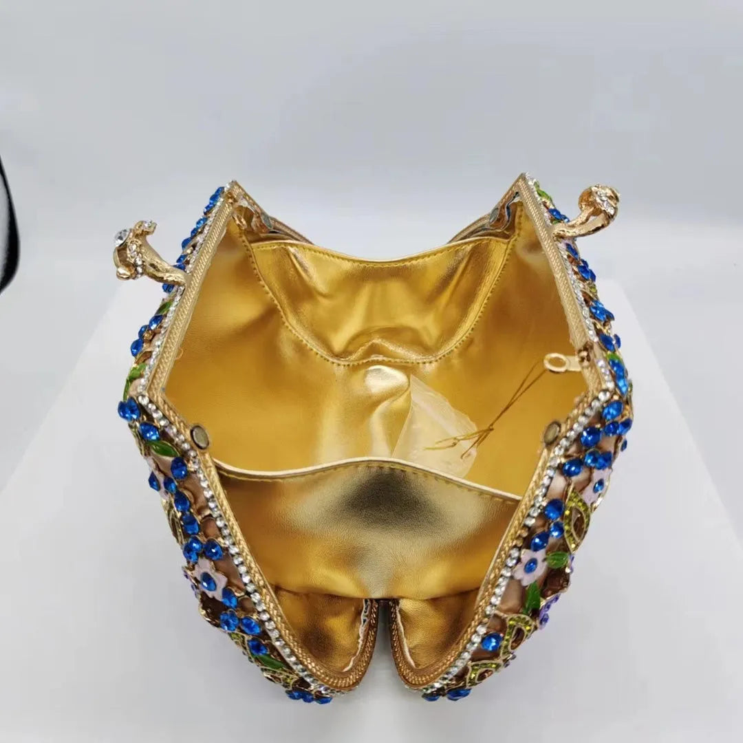 Gold oval metal evening clutch with enamel flower, hollow, diamond and dripping oil detail, 22cm long