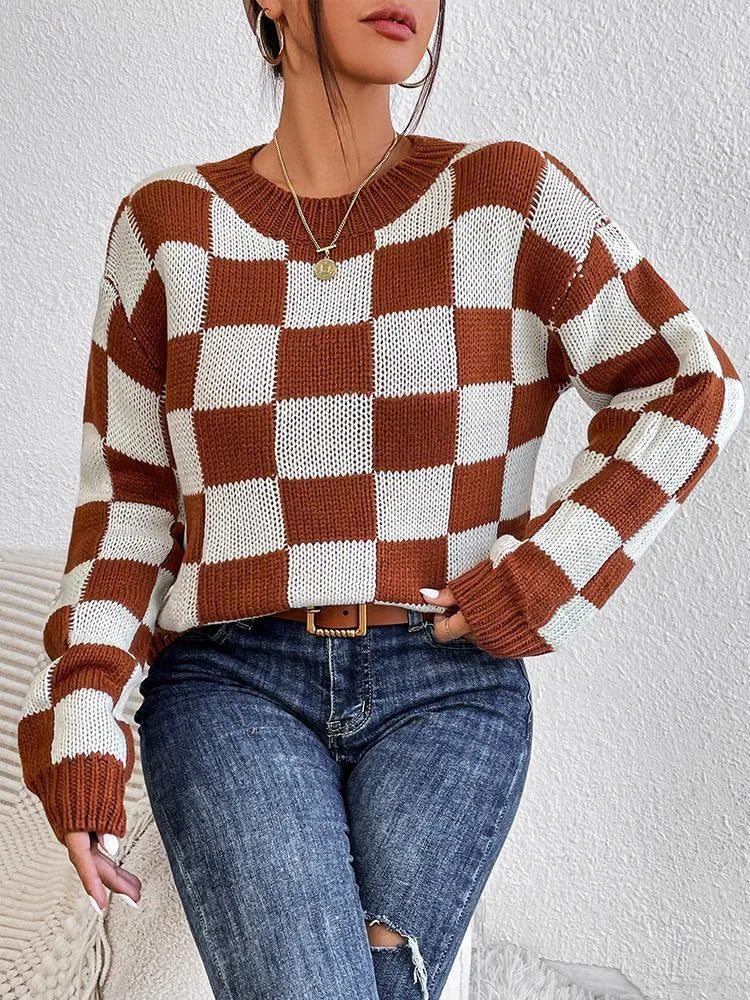 Dark brown plaid pattern pullover sweater with long sleeves and round neck, laid flat showing full design