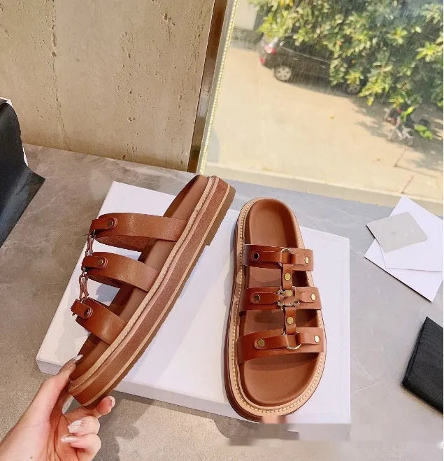 Women's white patent leather Roman sandal slippers with sheepskin upper on a wooden floor