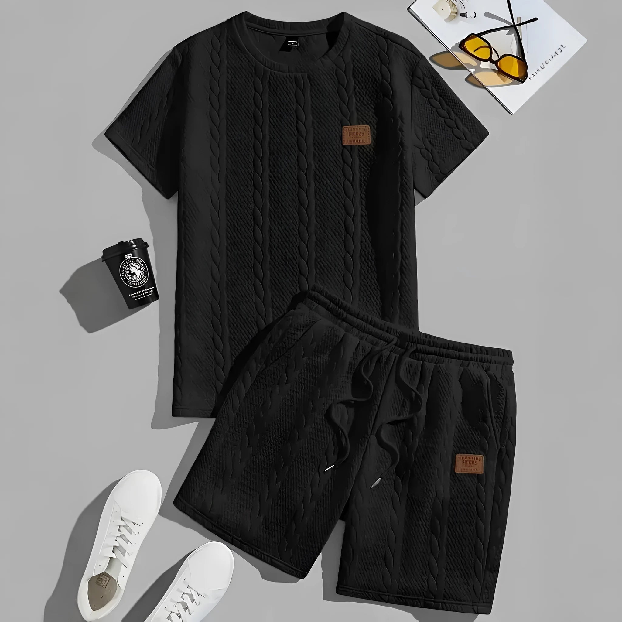Men's black polyester sports two-piece set with rib short sleeves and a patch design detail.