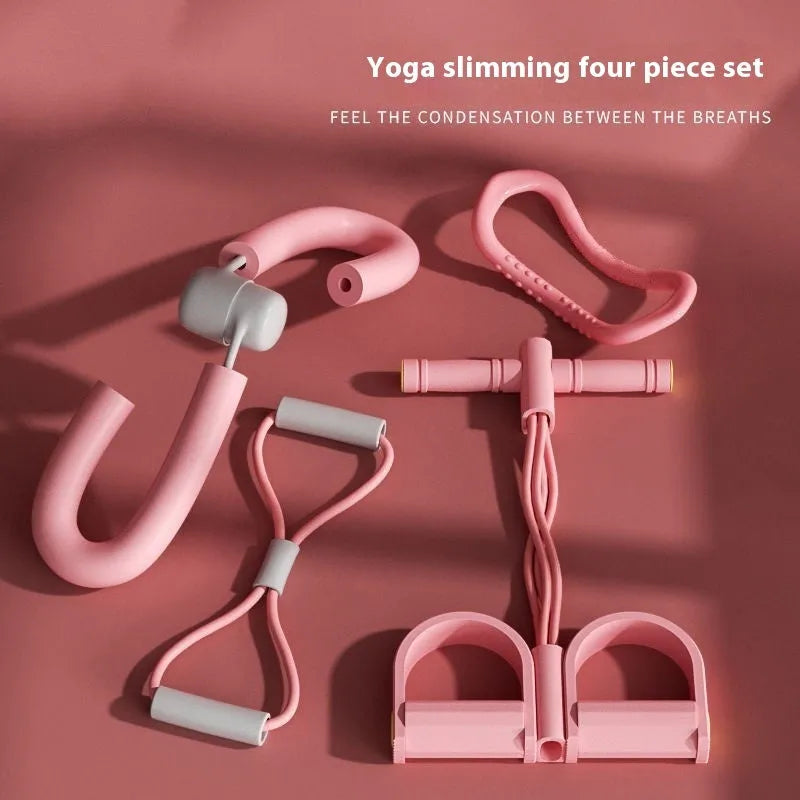 Yoga four piece set with leg stretching device, yoga ring, pedal tensioner, and figure eight tension rope on a mat