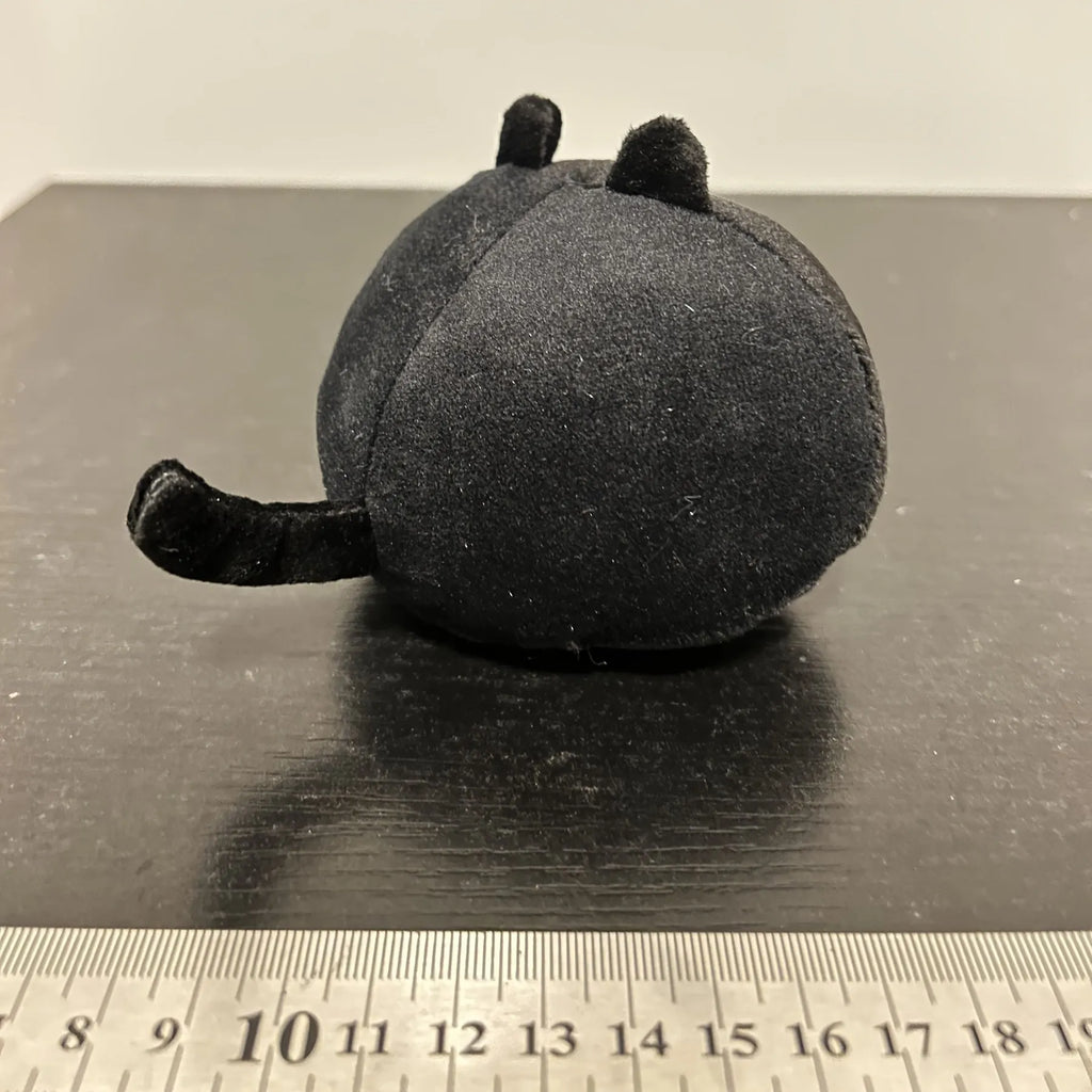 Fluffy black cat plush toy with soft texture, shown as a decorative cushion