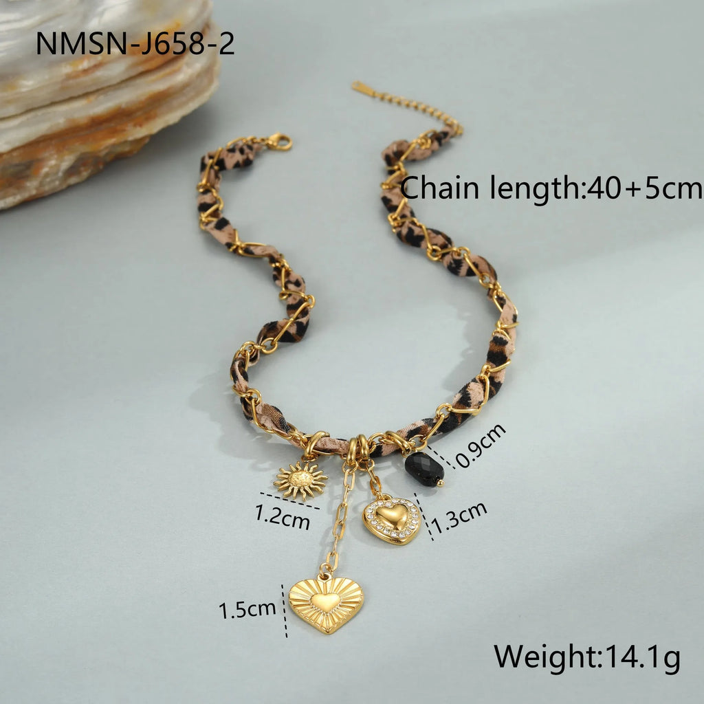 Close-up of a stainless steel necklace with a geometric leopard love pendant on an adjustable 18K-plated chain.