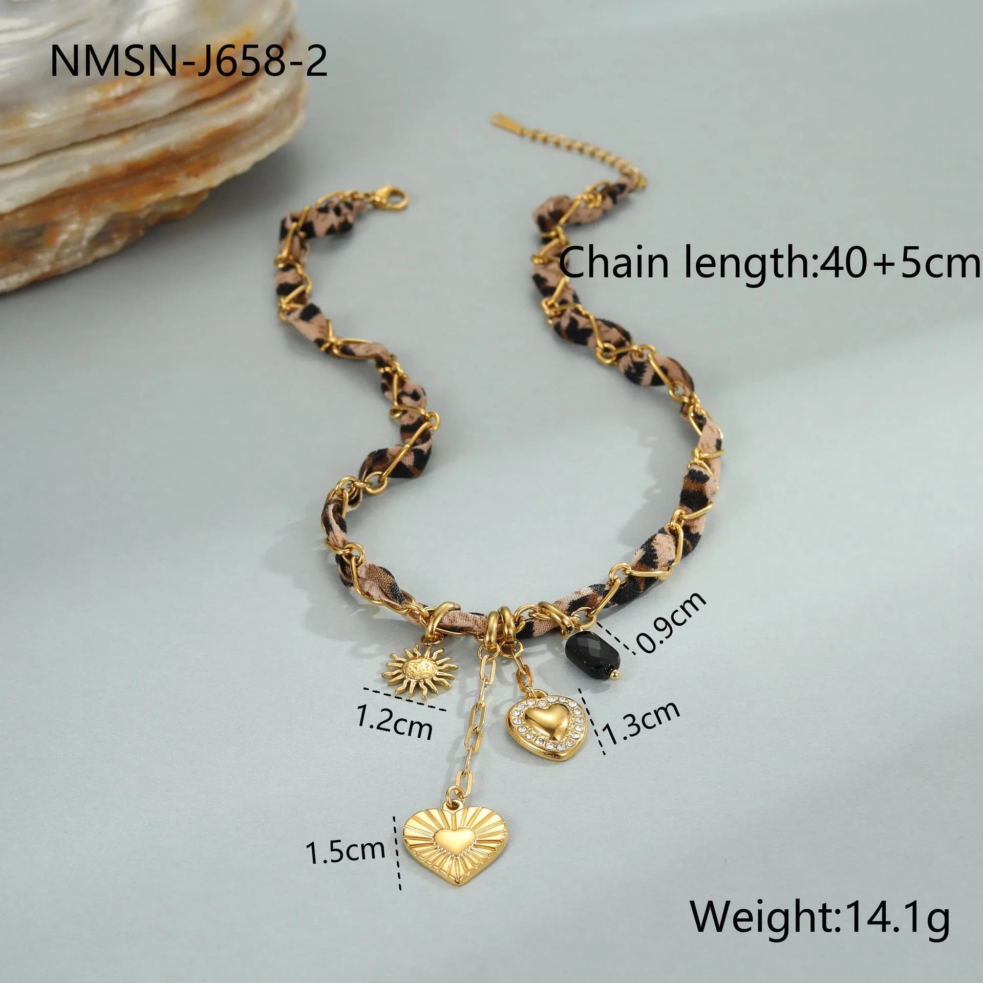 Close-up of a stainless steel necklace with a geometric leopard love pendant on an adjustable 18K-plated chain.