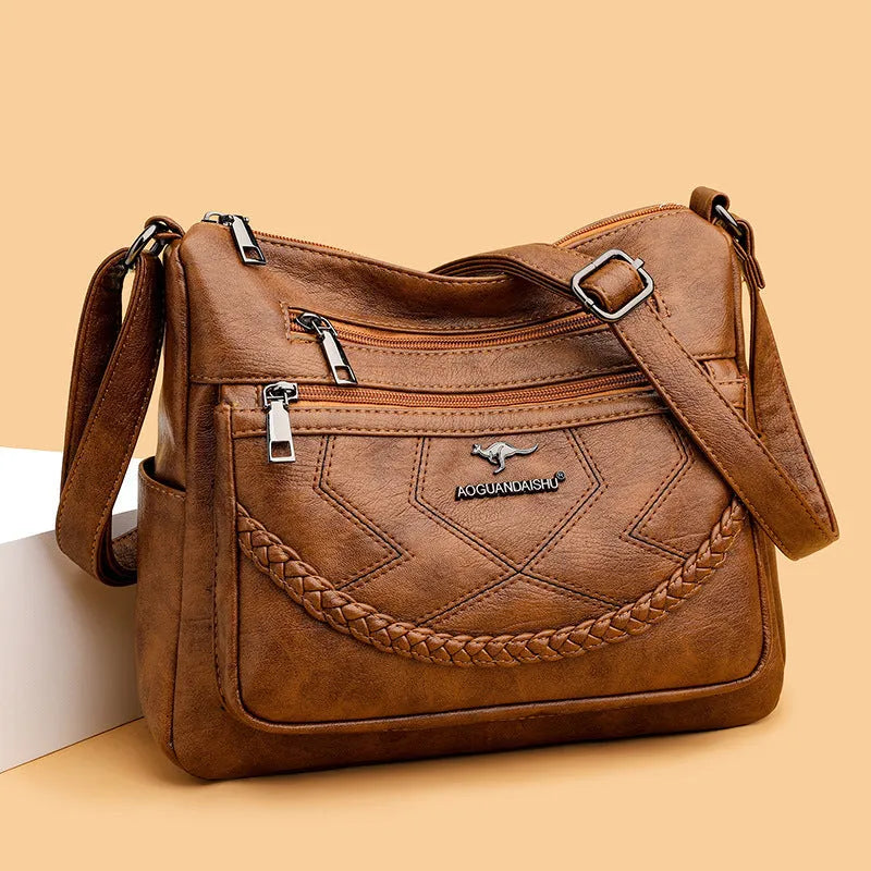 Black soft PU leather shoulder bag with crossbody strap, showing 30cm width and zippered internal organiser