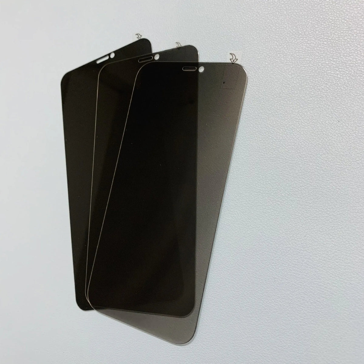 Tempered glass privacy screen protector for iPhone showing narrow viewing angle effect.