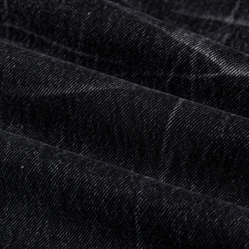 Men's black straight-leg jeans with faded lightning crack pattern on cotton denim