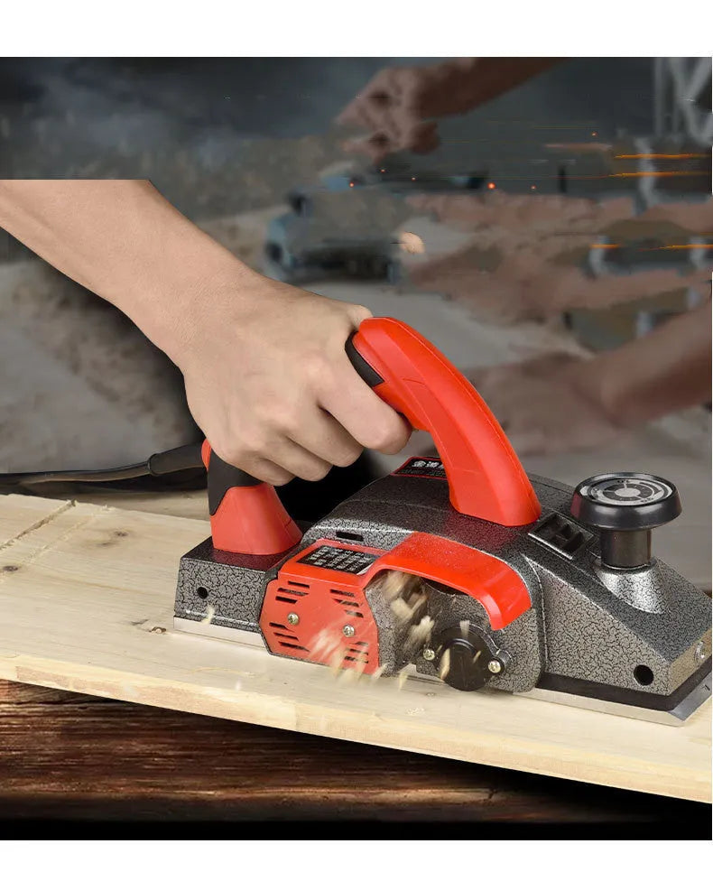 Red electric push planer with aluminium body, 82mm planing width, for woodworking tasks