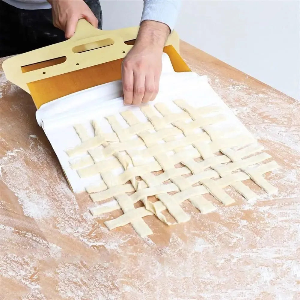 White plastic pizza transfer shovel with handle and hanging hole on a kitchen counter.