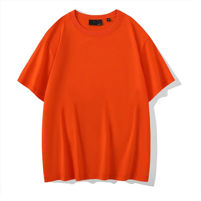 Solid colour loose fit cotton t-shirt with round neck and drop shoulder sleeves on a hanger