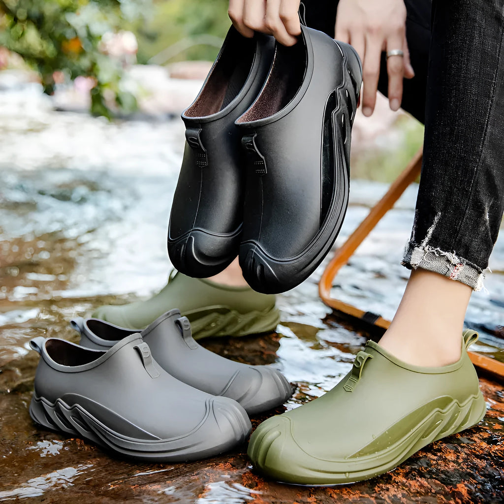 Men's short ankle-height plastic rain boot in a solid colour on a plain background.