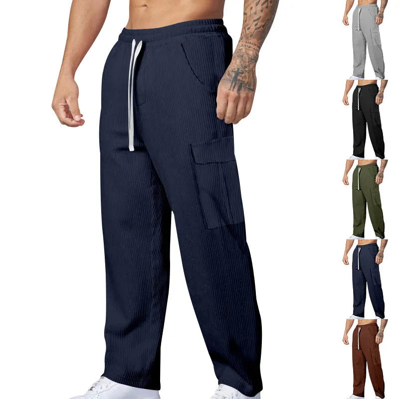 Men's straight-leg corduroy trousers in navy blue with drawstring waist, showing texture detail and relaxed fit