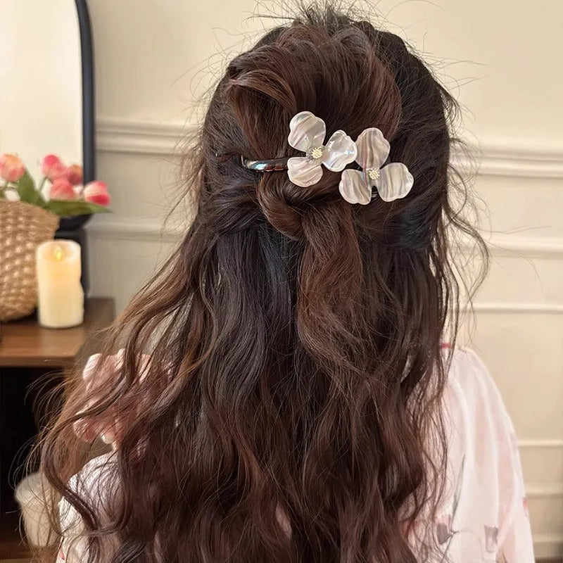 Retro flower hair bobby pin with coloured acrylic petals on a white background.