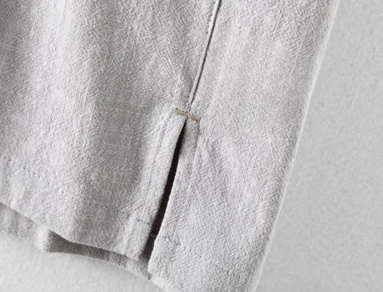 Men's loose fit linen shirt in solid colour with natural fabric texture, showing relaxed sleeve and collar design