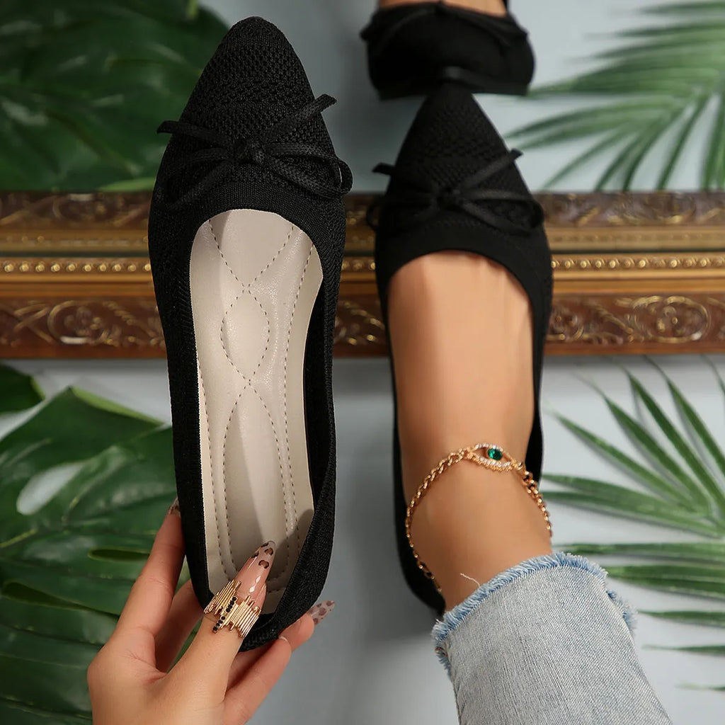 Women's knitted bow loafers with pointed-toe design in multiple colour options showing flat heel and rubber sole