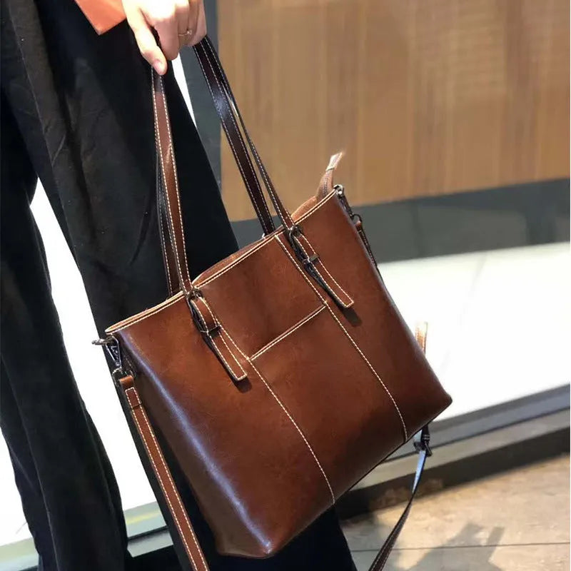 Brown genuine leather women's retro shoulder bag with three strap options and organised interior compartments
