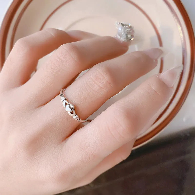 Retro silver coloured open band heart ring made of copper for women.