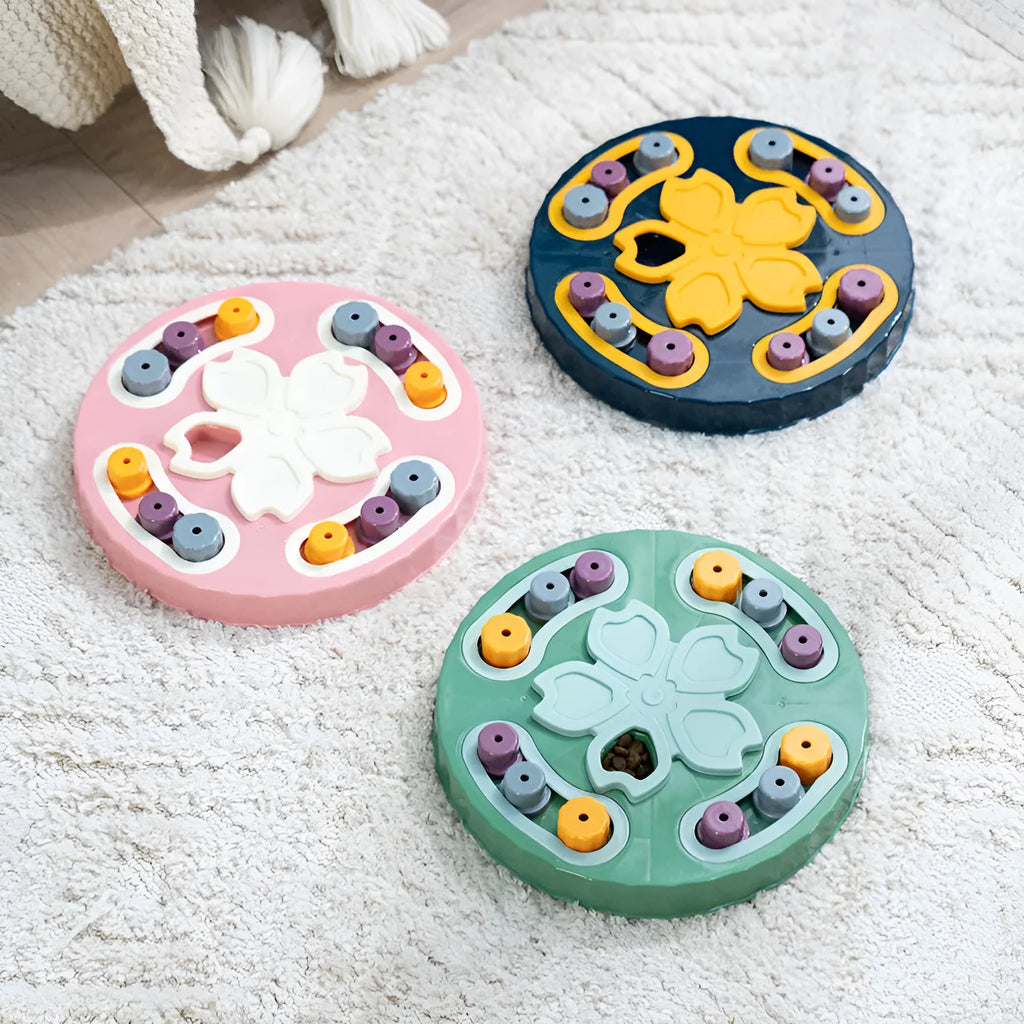 Blue silicone dog slow feeder mat with puzzle grooves and a suction base on a kitchen floor.