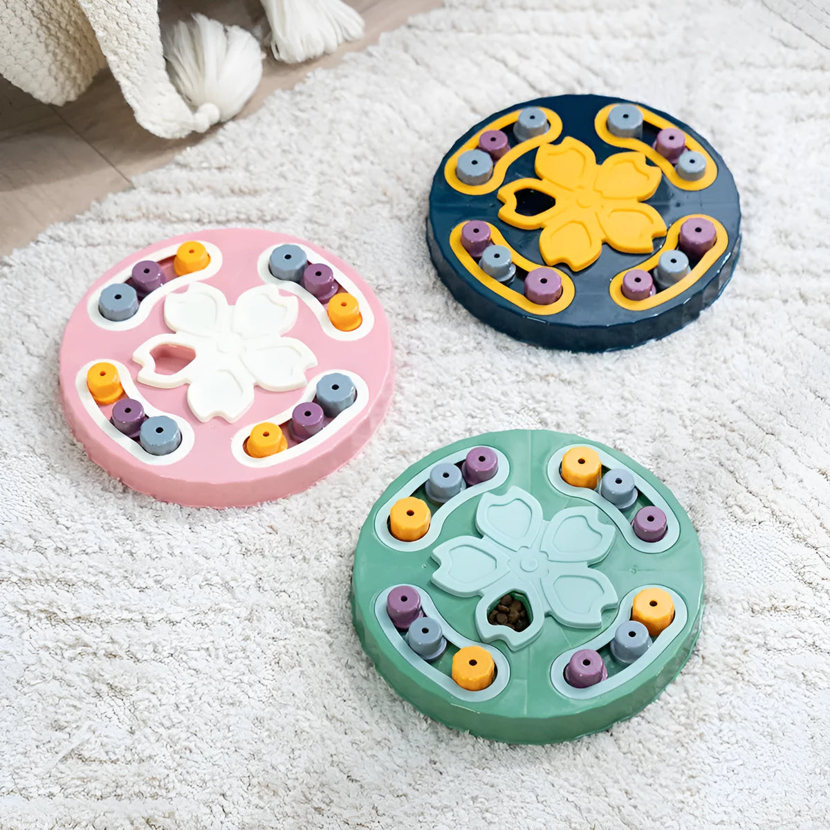 Blue silicone dog slow feeder mat with puzzle grooves and a suction base on a kitchen floor.