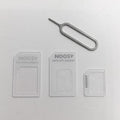 Four-in-one SIM card adapter kit with three plastic adapters and metal ejector pin on white background