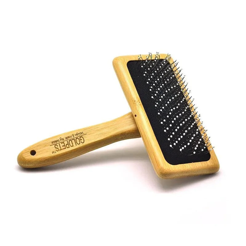 Goldpets bamboo wood pet slicker brush with stainless steel pins on a wooden table