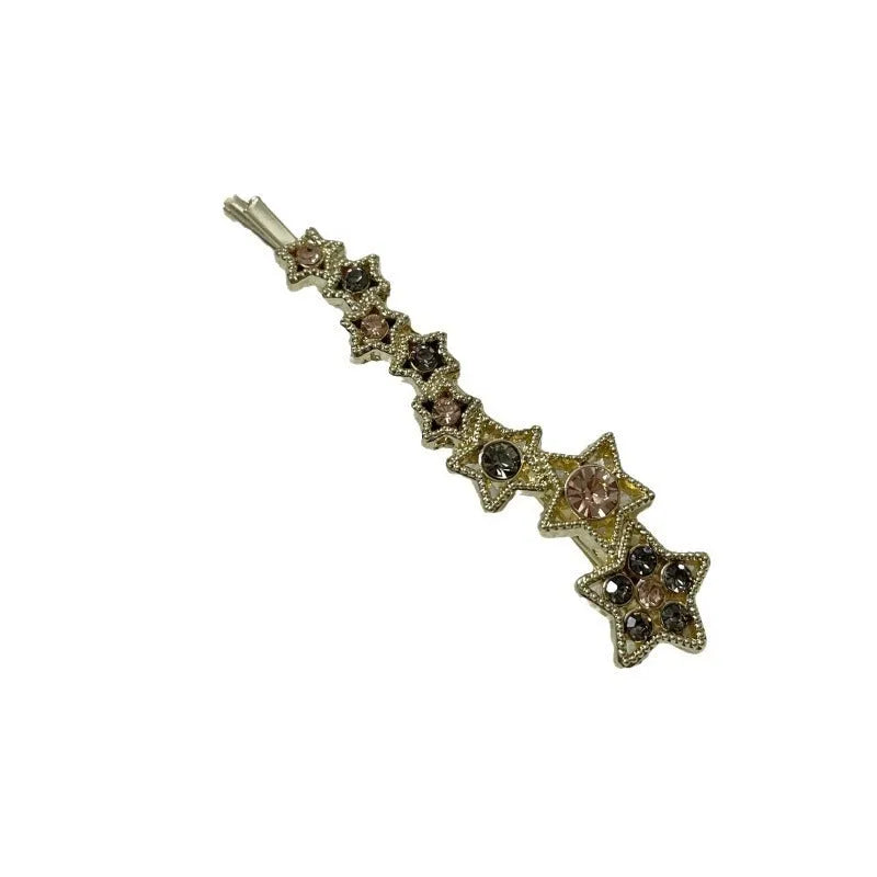 Gold metal hair barrette with a star charm and side clip for bangs.