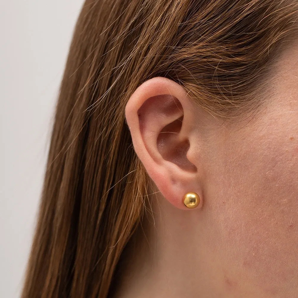 Stainless steel ball stud earrings with round geometric design in gold or silver finish, showing front and side views