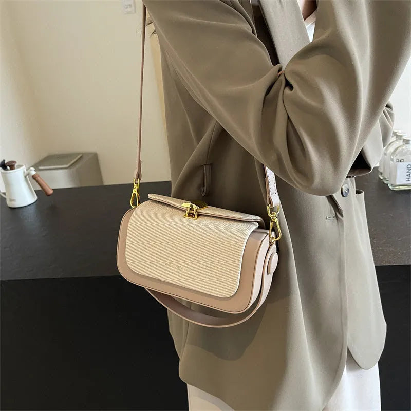 Women's PU leather messenger bag in horizontal square shape with contrast stitching and lock fastening