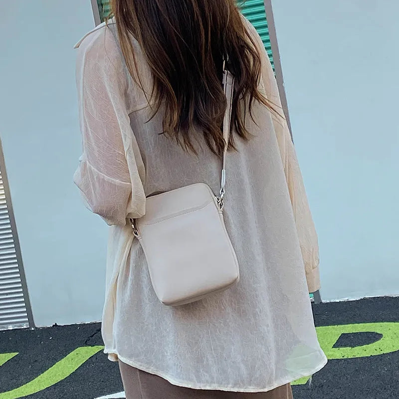 Solid colour mobile phone crossbody bag with adjustable strap, compact 14.5x5.5x19cm dimensions