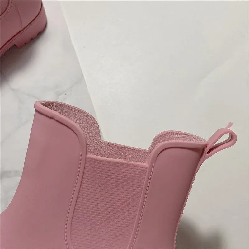 Pair of short rain boots in pink, milky white, or black with non-slip sole and mid-calf length