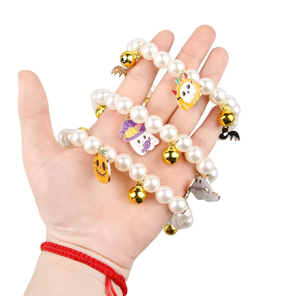 Halloween cat collar with simulated pearls and pumpkin designs in purple ghost, skull, and smiling motifs