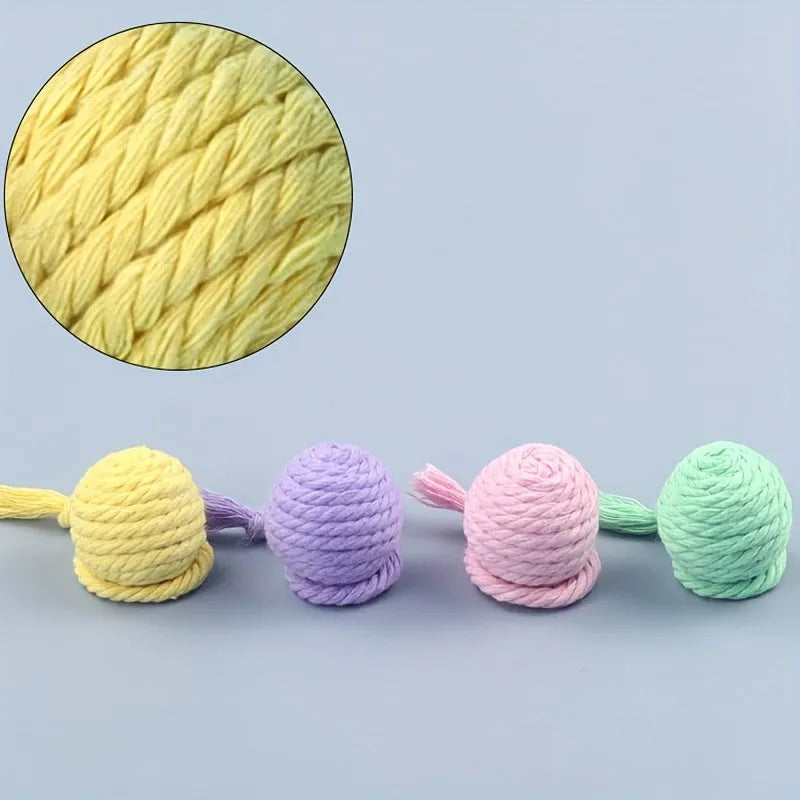 Colourful cat toy ball with attached rope and internal bell mechanism in green, pink, purple, or yellow options